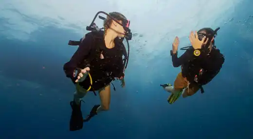 Two SSI Open Water students practicing basic underwater skills before booking their course with Echo Divers Koh Tao.