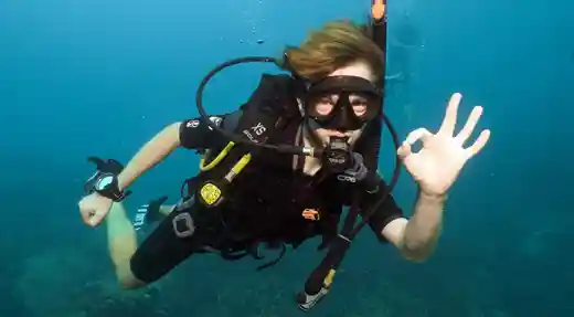SSI Deep Specialty student giving an OK signal while practising buoyancy and depth control during a deep training dive with Echo Divers Koh Tao.
