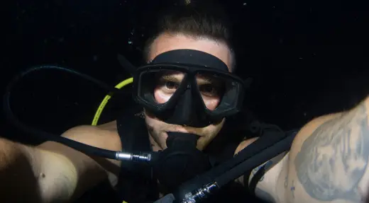 SSI Deep Specialty student giving an OK signal while practising buoyancy and depth control during a deep training dive with Echo Divers Koh Tao.
