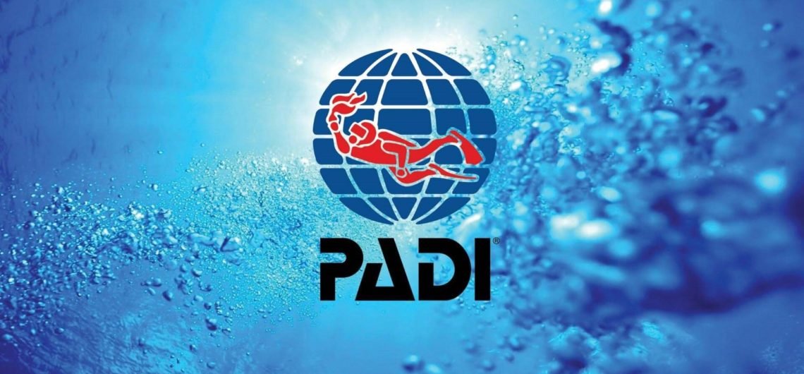 PADI logo on a blue underwater background with bubbles.