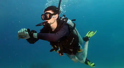 Echo Divers Koh Tao SSI Open Water course student practising buoyancy and trim above a sandy bottom, Koh Tao, Thailand