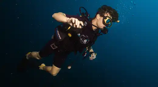Echo Divers Koh Tao SSI Open Water course student hovering underwater while practising buoyancy control, Koh Tao, Thailand