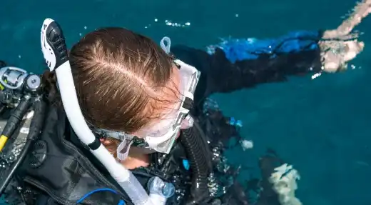 Echo Divers Koh Tao Echo Hostel guests chatting at reception in a relaxed social common area, Koh Tao, Thailand