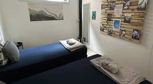 Echo Divers Koh Tao Echo Hostel guest relaxing on a rooftop chill area with sunset sea view, Koh Tao, Thailand