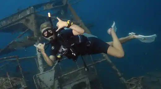Echo Divers Koh Tao Echo Hostel guests chatting at reception in a relaxed social common area, Koh Tao, Thailand