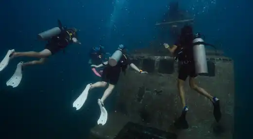 Echo Divers Koh Tao Echo Hostel guests chatting at reception in a relaxed social common area, Koh Tao, Thailand